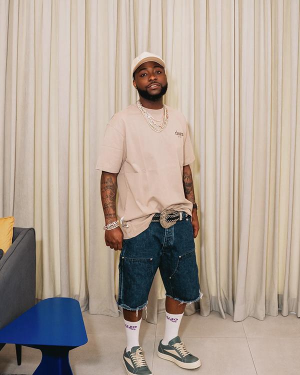 Davido in Beige Tee, Denim Shorts & Green Sneakers Laid-Back Street Style | OutfitLibrary.com