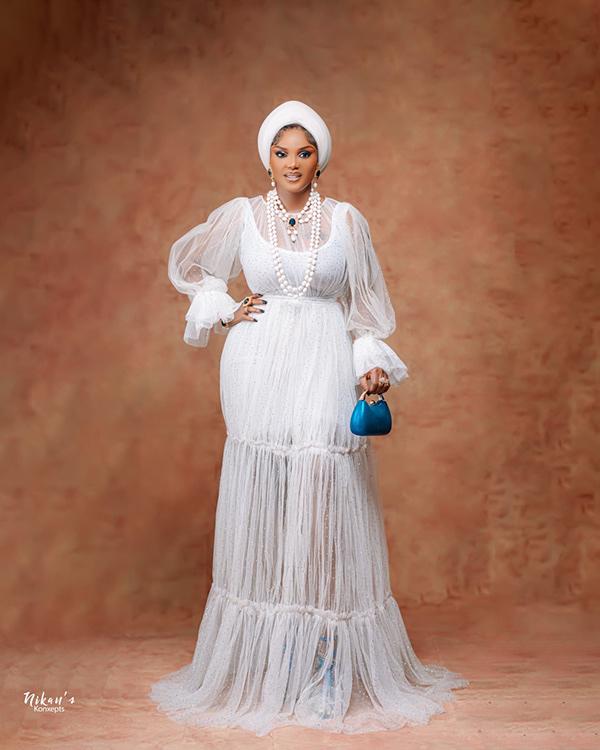 Iyabo Ojo Radiates in White Layered Maxi Dress, Sheer Sleeves & Turban | OutfitLibrary.com