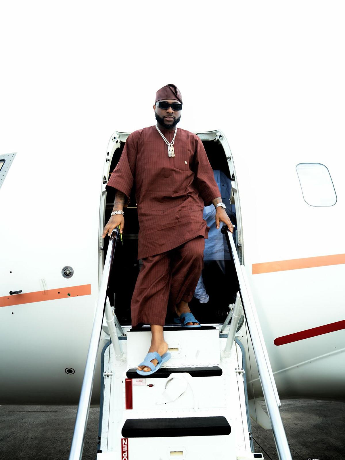 Davido Lands in Effortless Brown Kaftan Set & Slides at Private Jet Arrival | OutfitLibrary.com